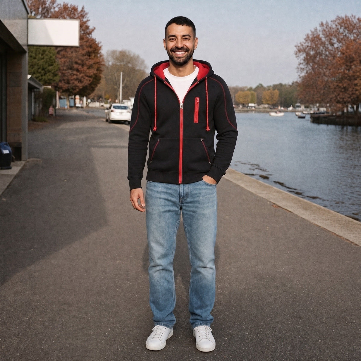 Man wearing black zip hoodie with red contrast trim, smiling outdoors | Chaps London