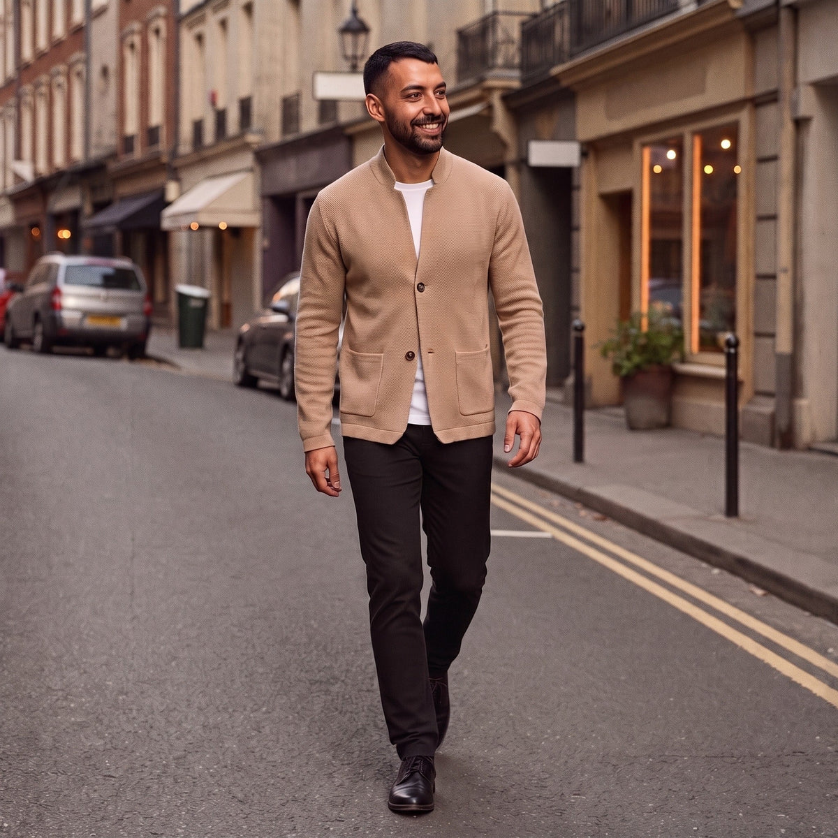 Man wearing tan textured knit cardigan with white tee, walking outdoors | Chaps London