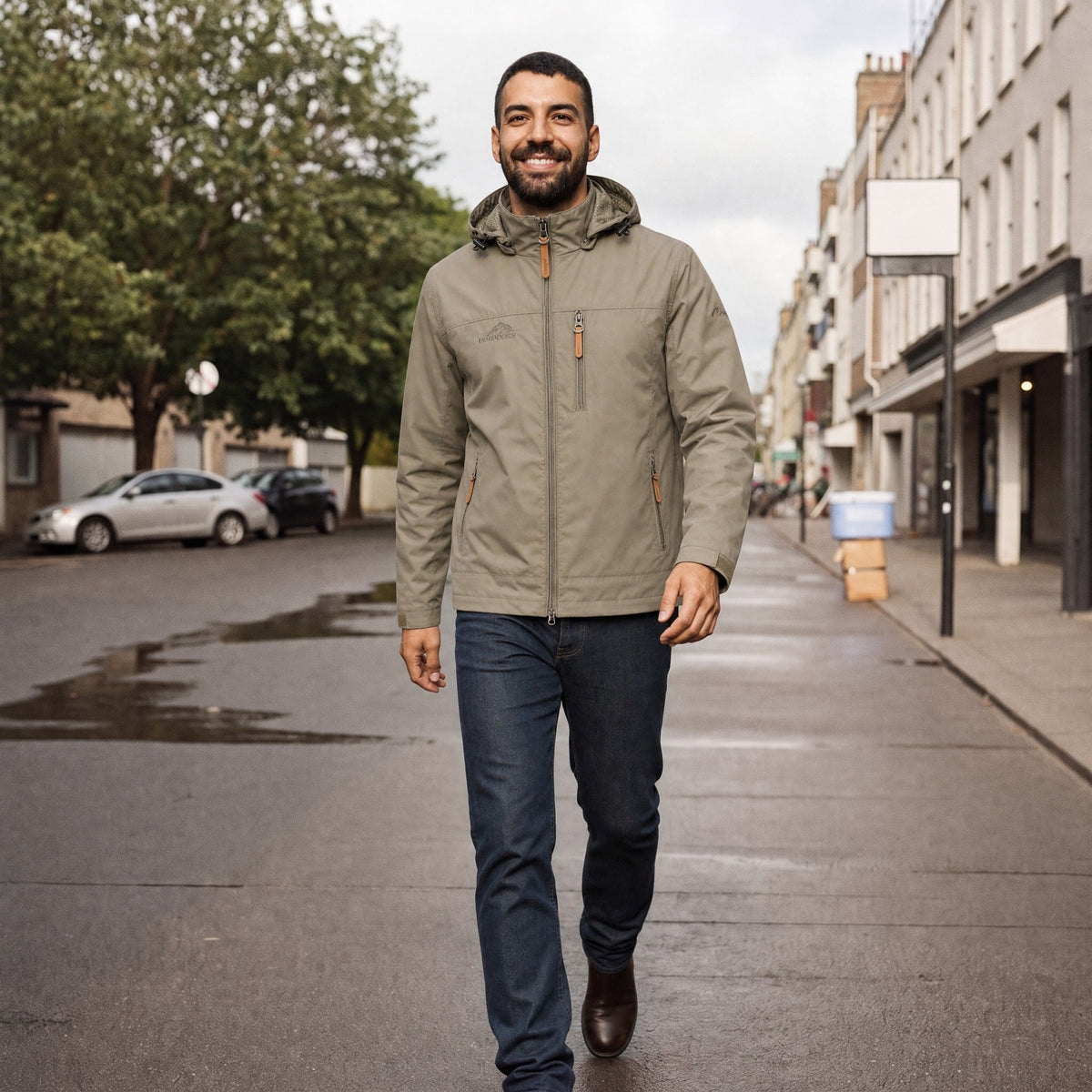 Man wearing beige hooded windbreaker jacket with dark jeans on street | Chaps London