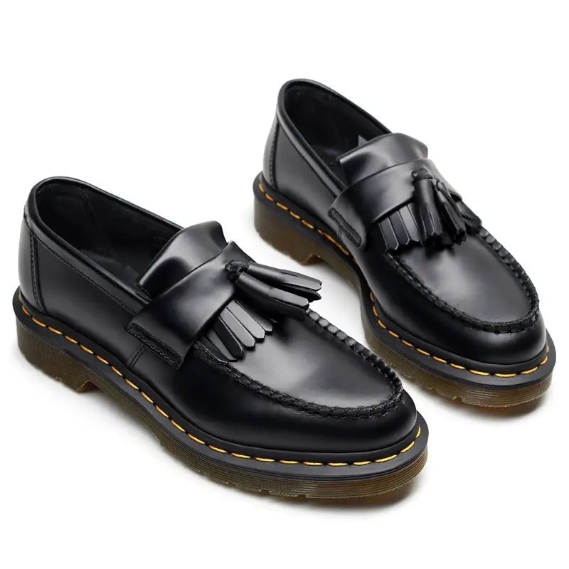 Pair of men's black chunky tassel loafers, front angled view from above
