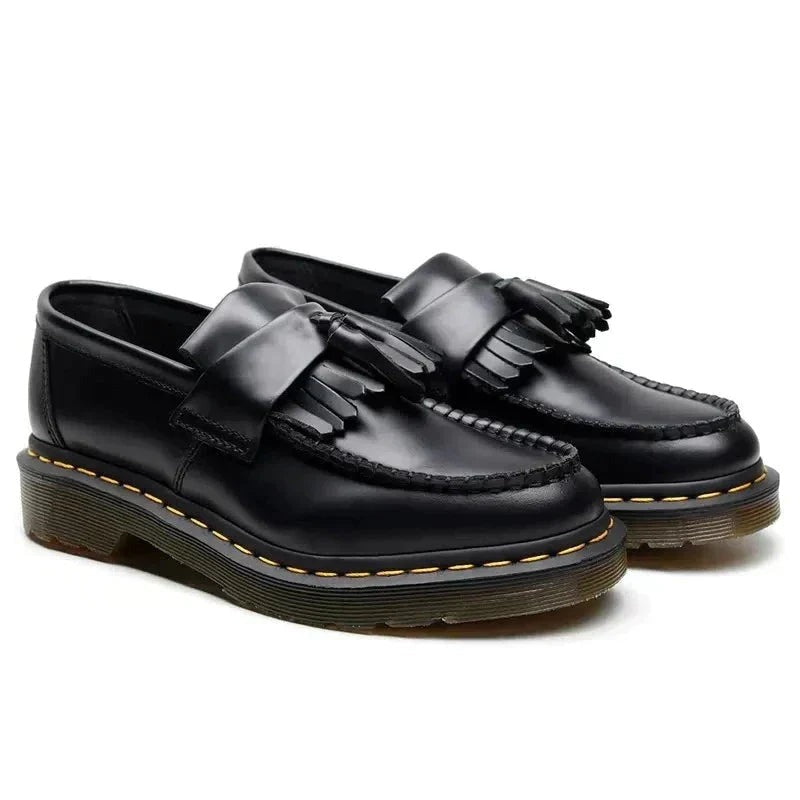 Pair of men's black chunky tassel loafers, front angled view