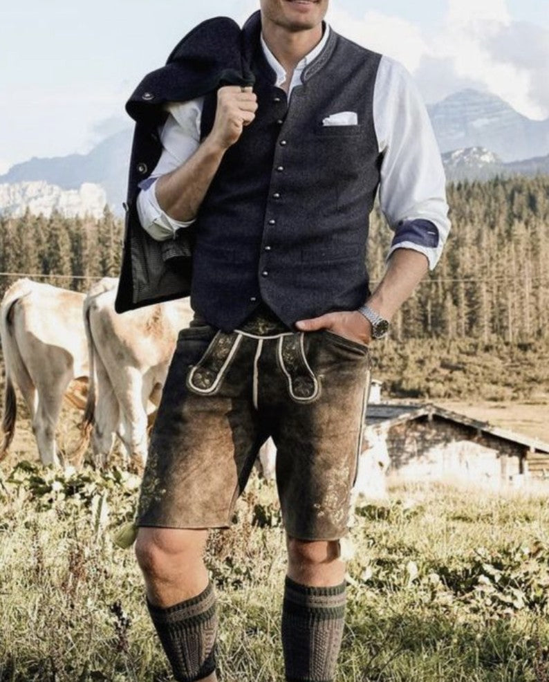 Men's brown suede lederhosen with traditional embroidery, worn with a waistcoat and knee socks