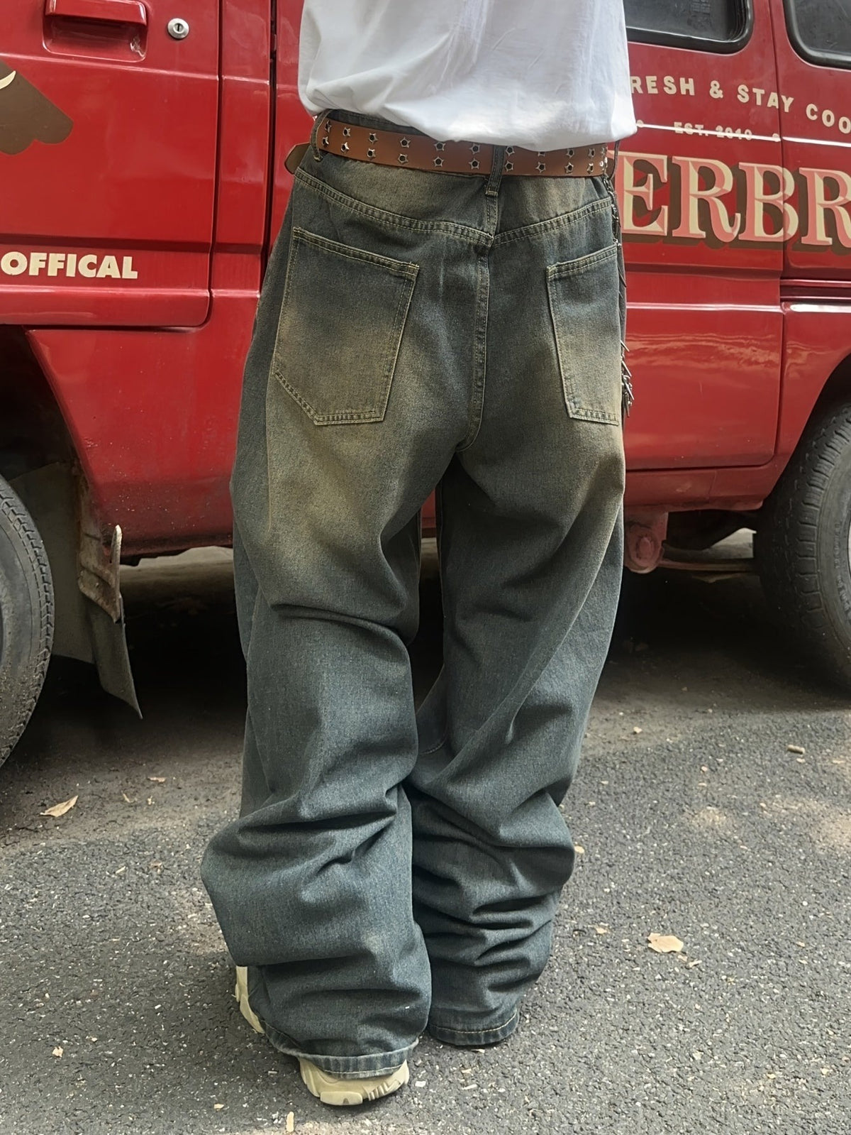 Men's baggy wide leg jeans in a vintage wash, back view