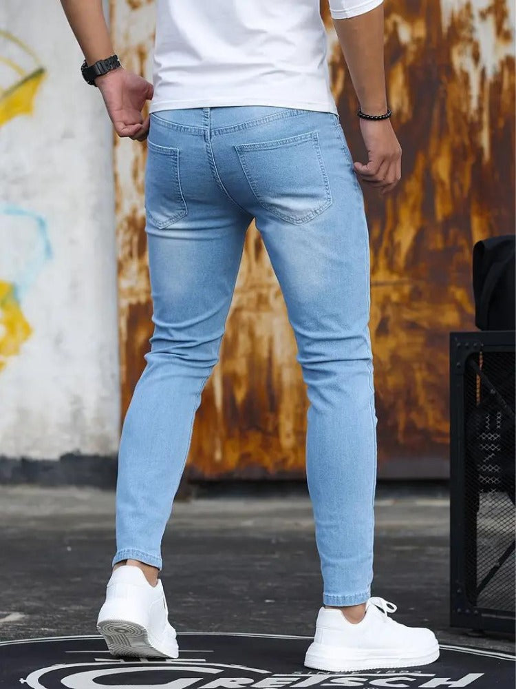 Men's light blue skinny jeans, back view