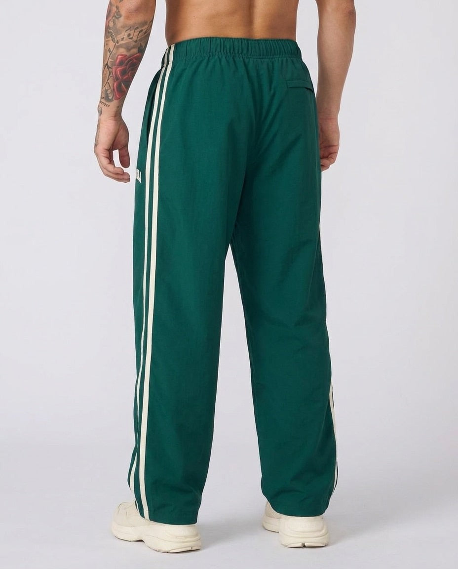 Men's green side-stripe tracksuit bottoms, back view