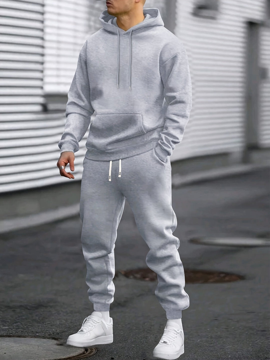Man in a grey hoodie and matching joggers tracksuit set, standing on a street | Chaps London