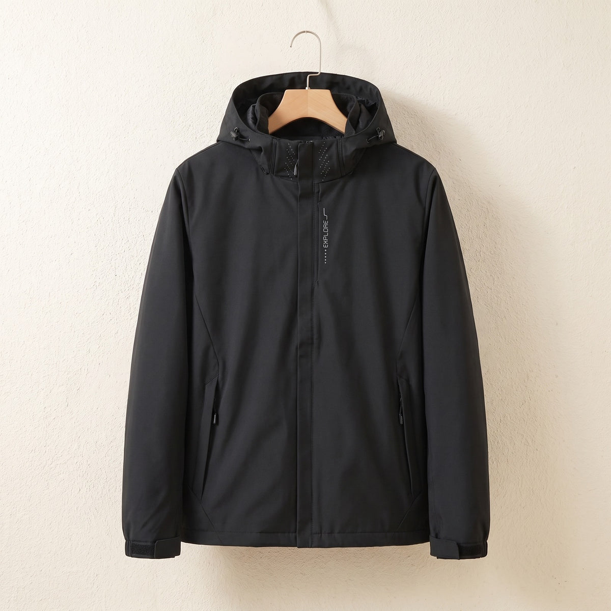 Black waterproof jacket with hood on a hanger