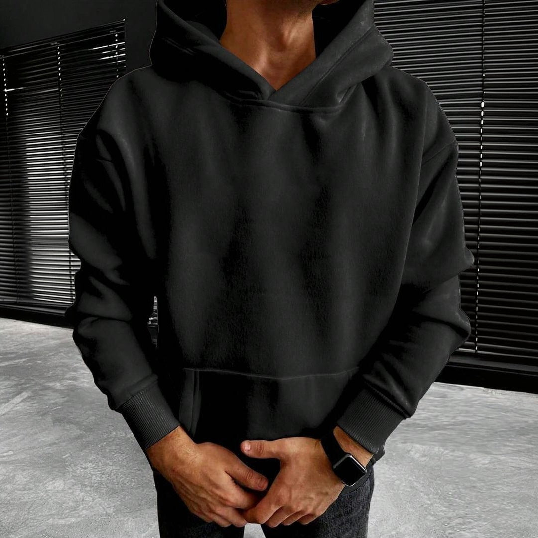 Black plain hoodie with kangaroo pocket worn by man outdoors | Chaps London