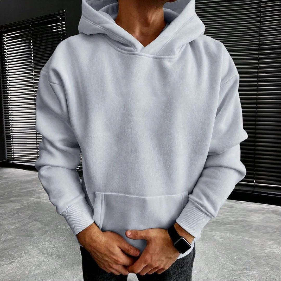 Light grey hoodie with kangaroo pocket worn by man indoors | Chaps London