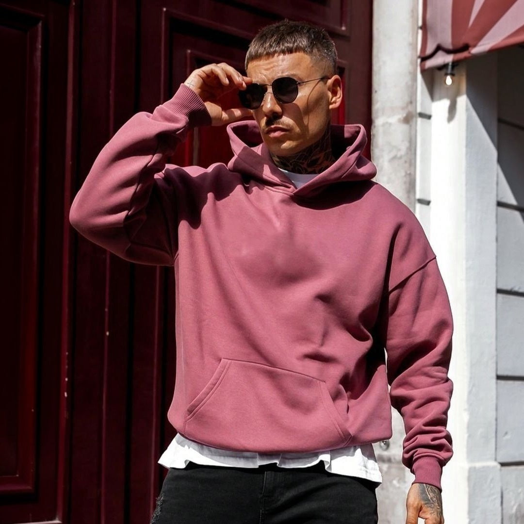 Man wearing maroon plain hoodie with kangaroo pocket, outdoors in sunlight | Chaps London