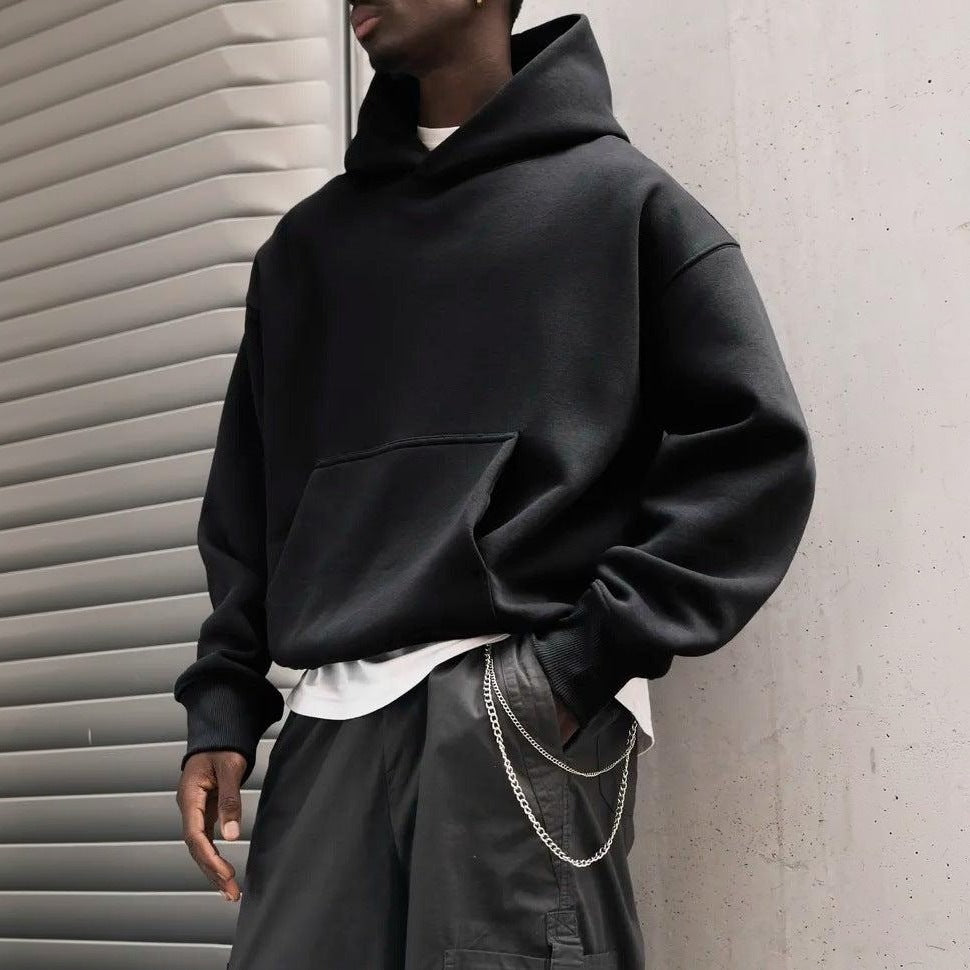 Man wearing oversized black hoodie with white shirt underneath, chain detail | Chaps London