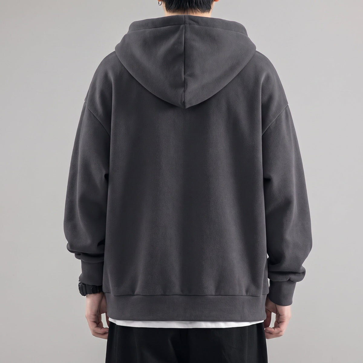 Dark gray oversized zip hoodie worn by man, back view, hood up | Chaps London