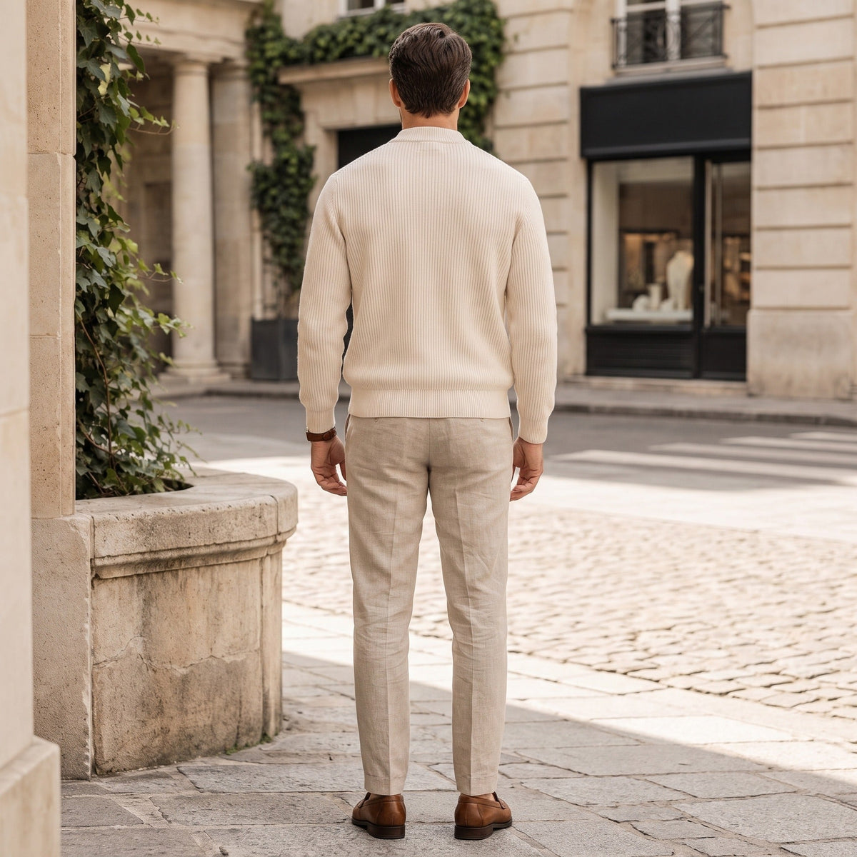 Man wearing beige ribbed zip cardigan with trousers, standing outdoors on street | Chaps London