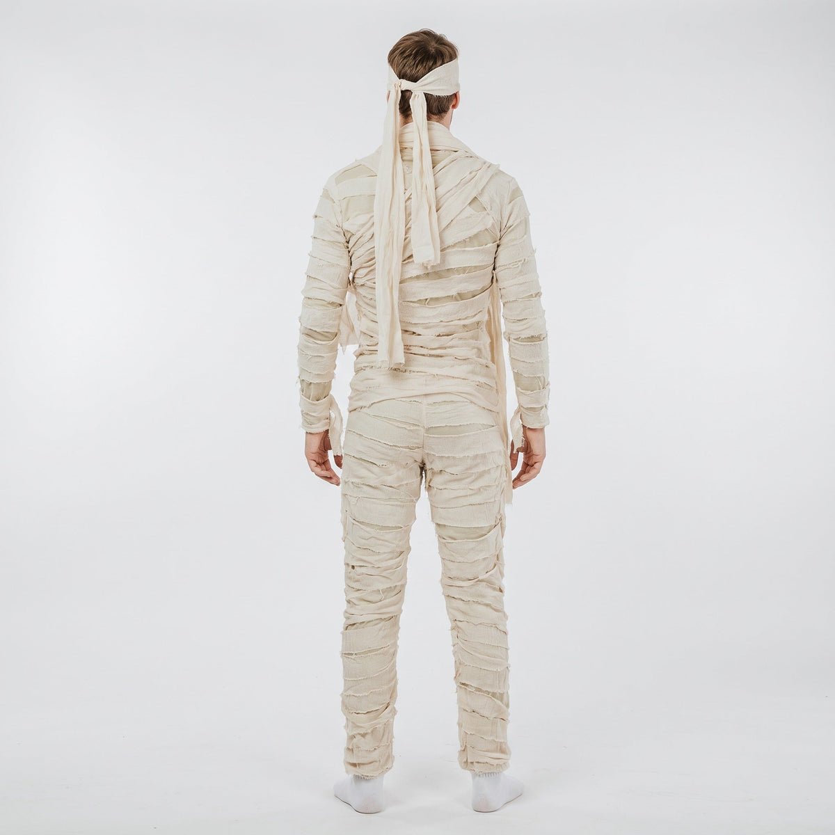 Man wearing beige mummy costume jumpsuit with headband, rear view | Chaps London