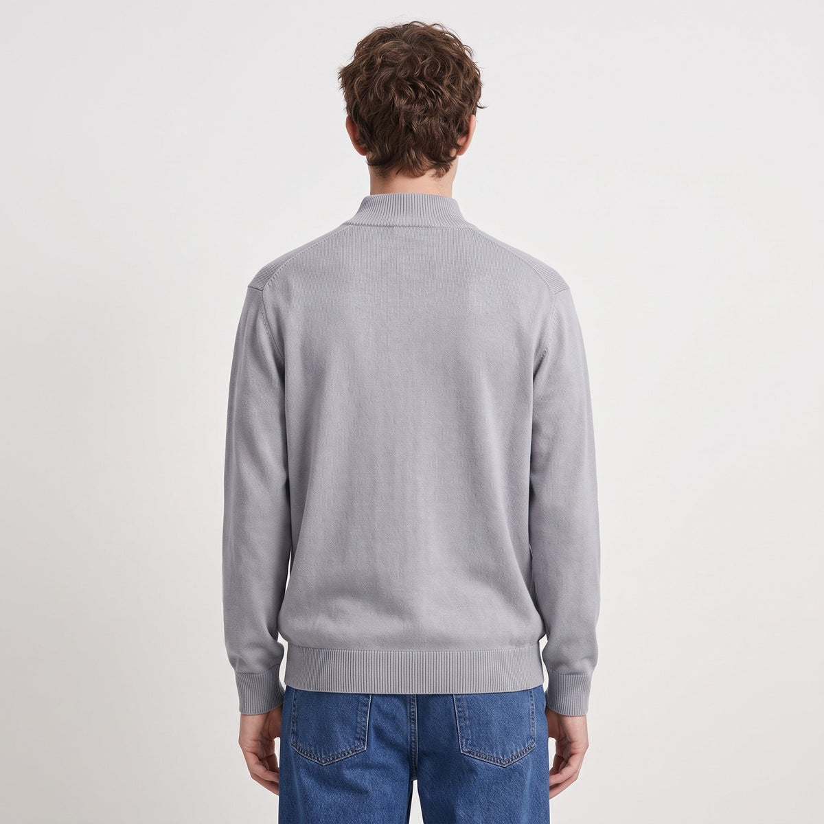 Man wearing grey half-zip jumper and blue jeans, back view | Chaps London