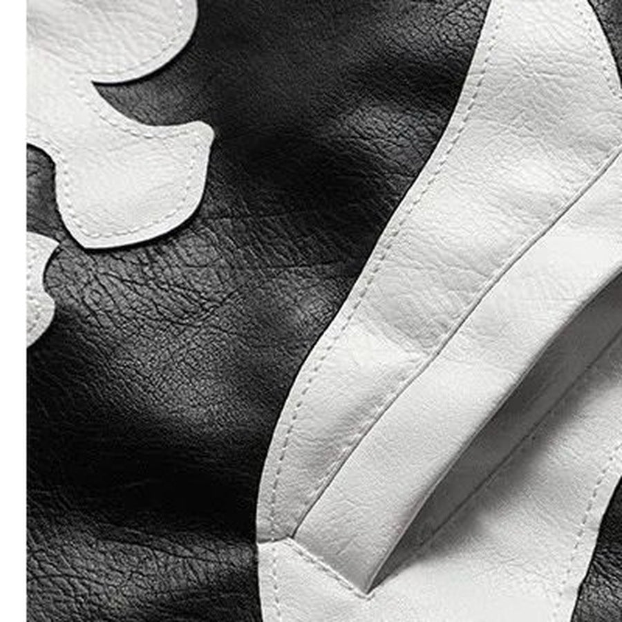 Close-up of black faux leather jacket with white bone applique detail | Chaps London