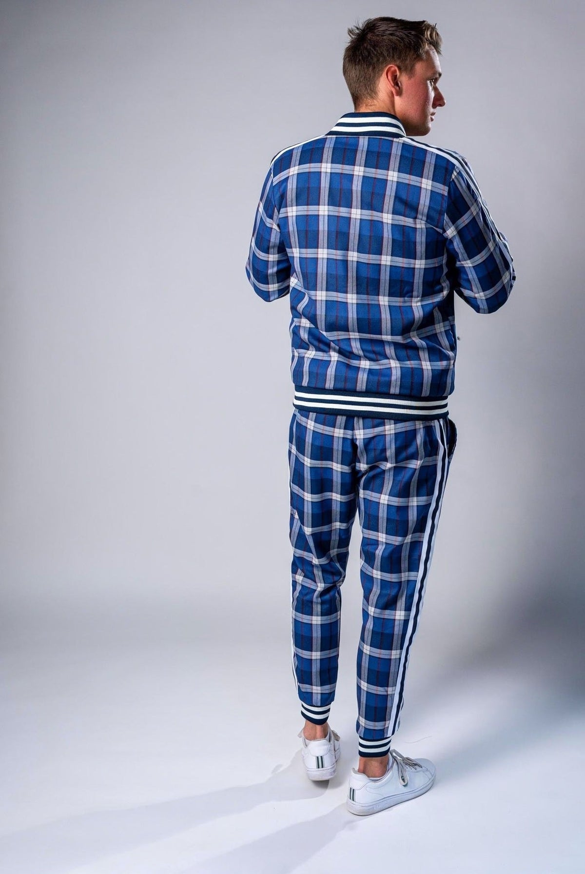 Man wearing blue and white checkered tracksuit with striped trim, rear view | Chaps London