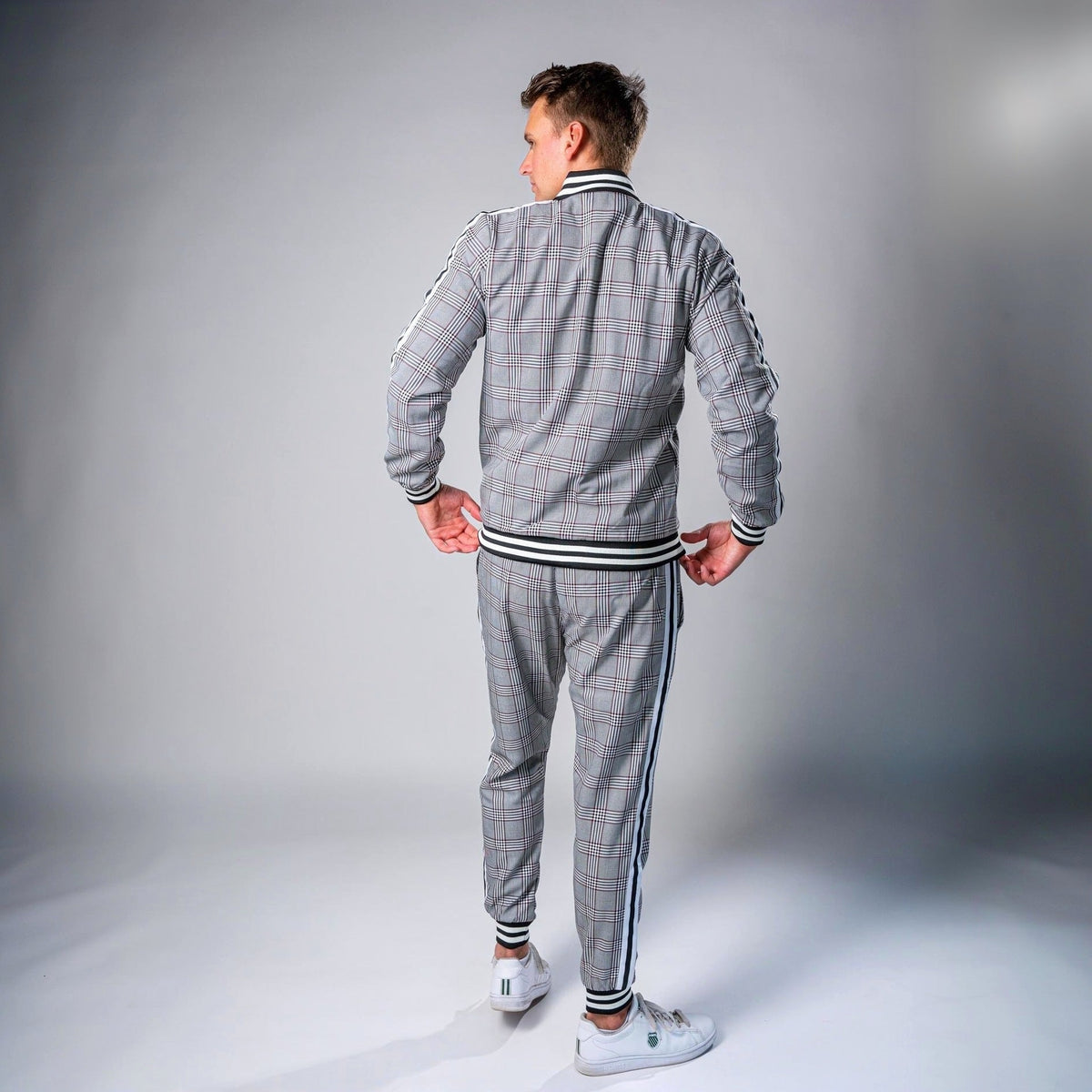 Man wearing grey check tracksuit with striped trim, zip jacket and joggers, back view | Chaps London