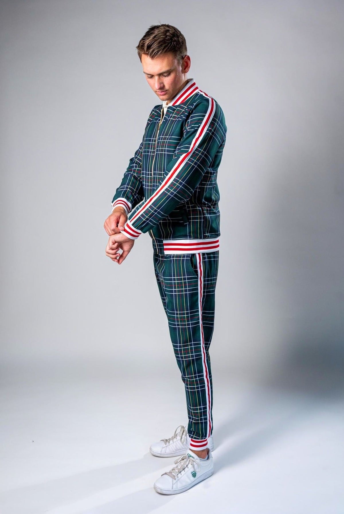 Man wearing green plaid tracksuit with red and white stripe detailing | Chaps London