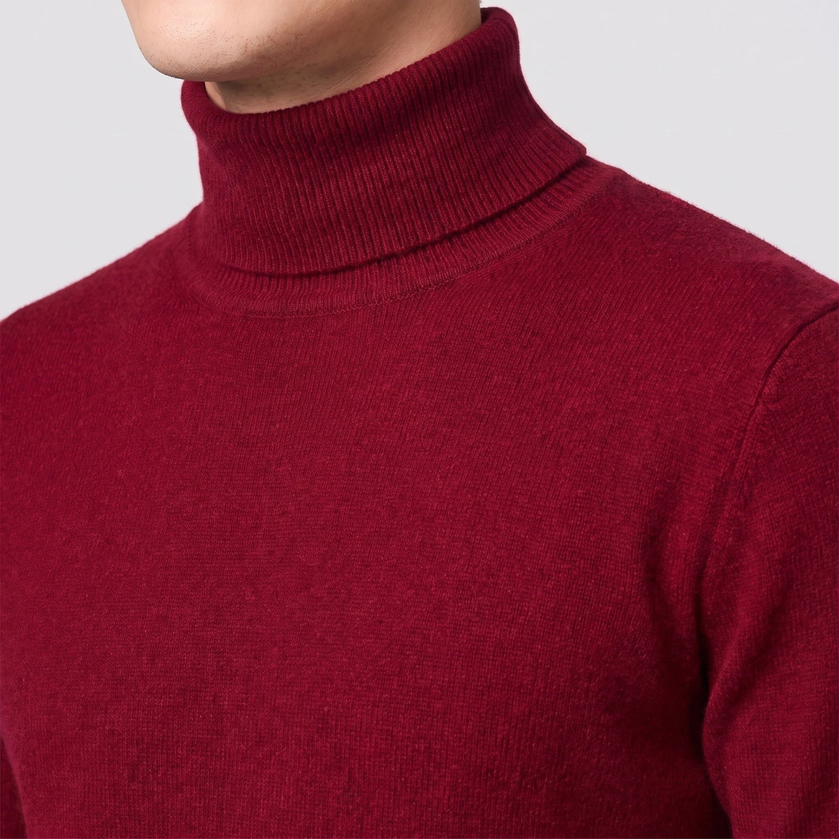 Burgundy fine knit turtleneck jumper worn by man, close-up view | Chaps London