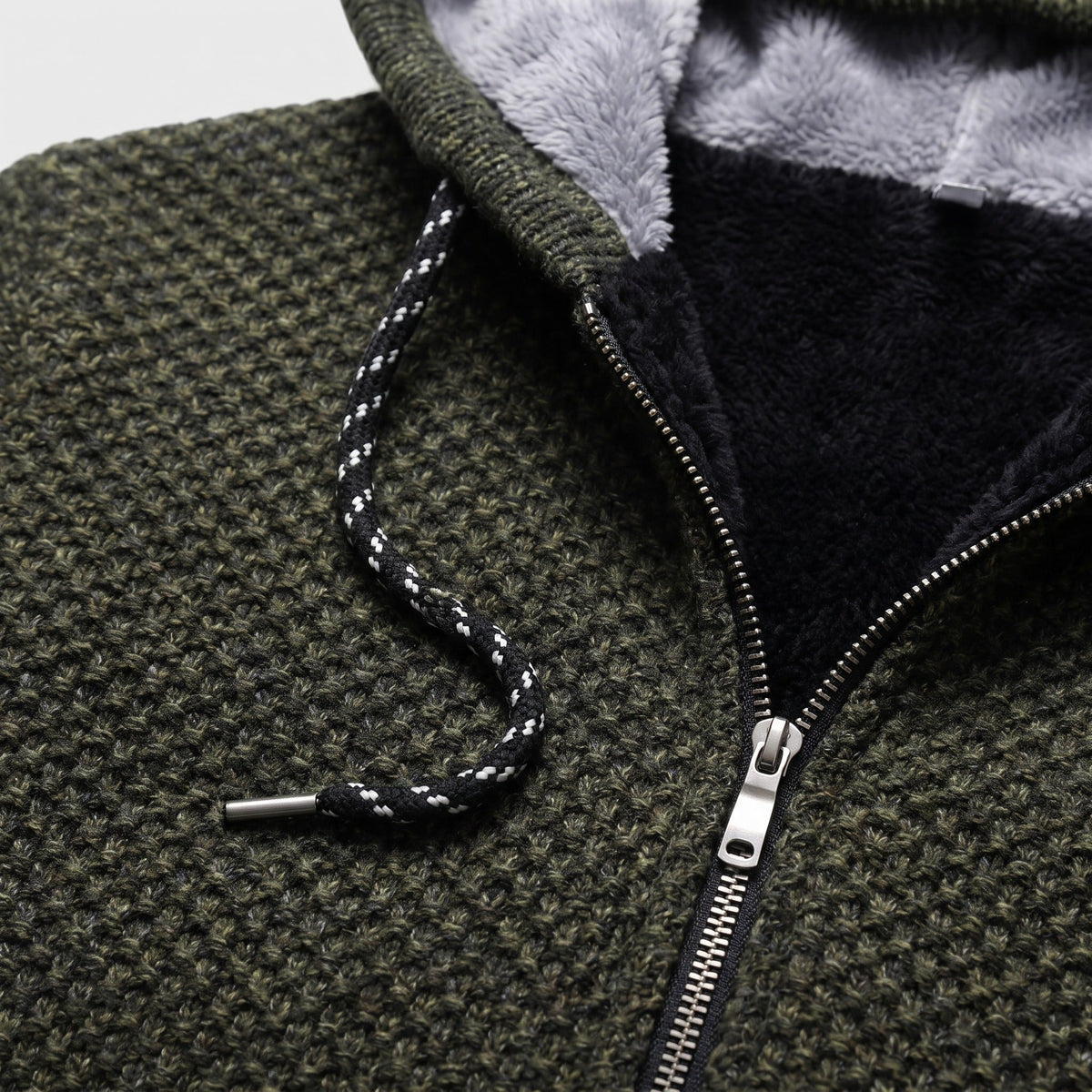 Close-up of olive chunky knit hoodie zipper and drawstring detail, fleece lining visible | Chaps London