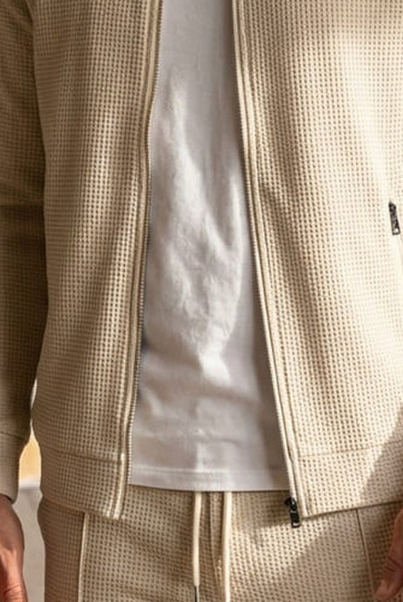Beige waffle-texture zip jacket worn by man, paired with matching sweatpants | Chaps London