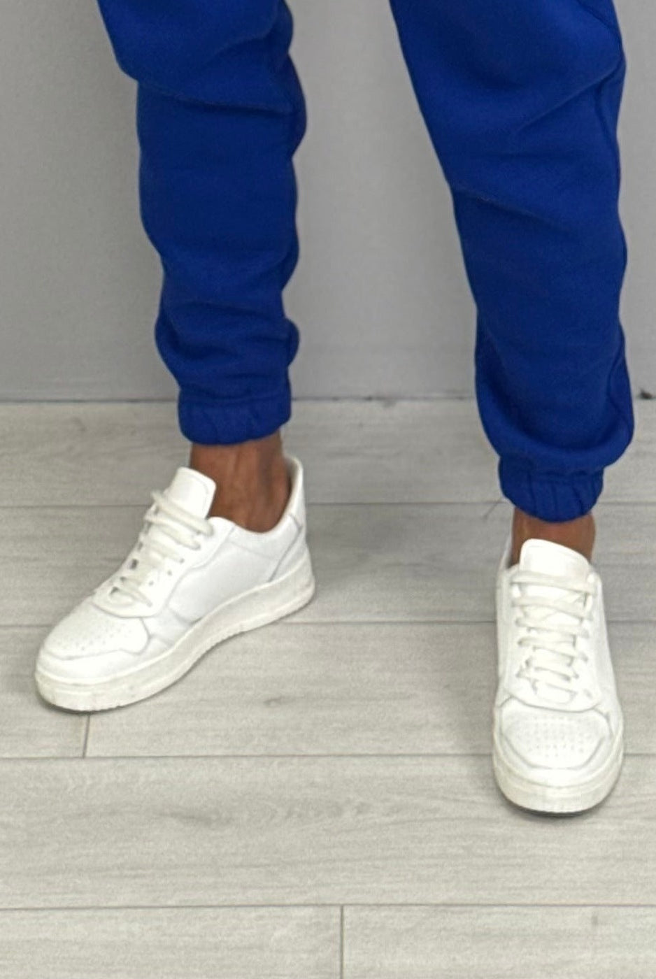 Blue cuffed jogger pants worn by person with white sneakers | Chaps London