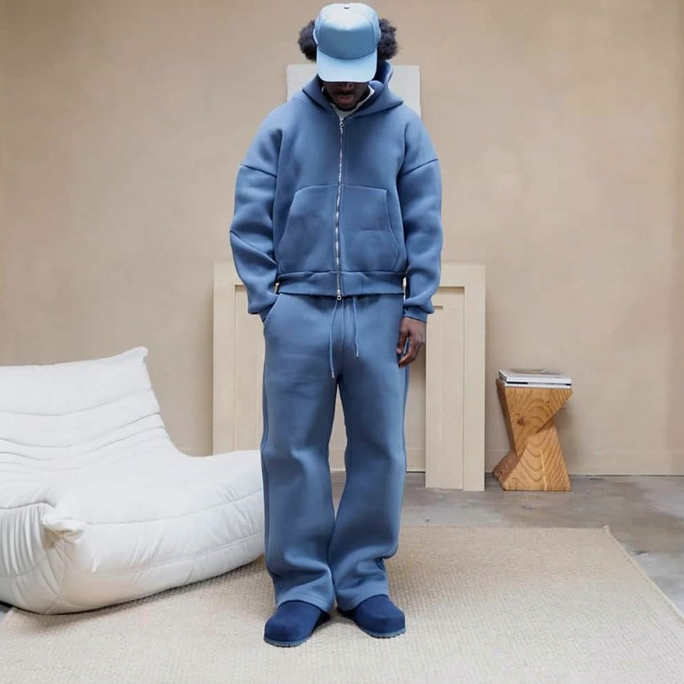 Man wearing blue zip hoodie and matching wide leg joggers, indoor setting | Chaps London