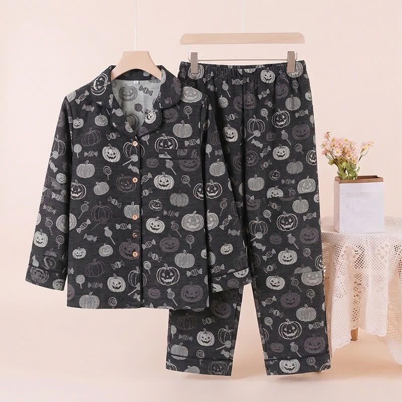 Black pyjama set with pumpkin print, hanging on display, pants shown flat | Chaps London