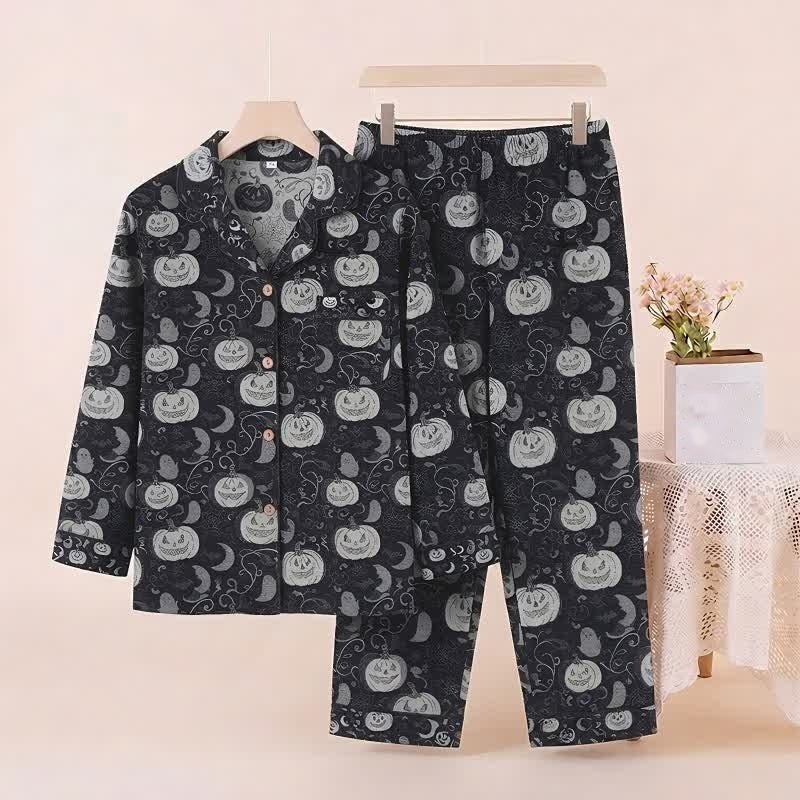 Black pyjama set with pumpkin and moon print, displayed on hanger | Chaps London