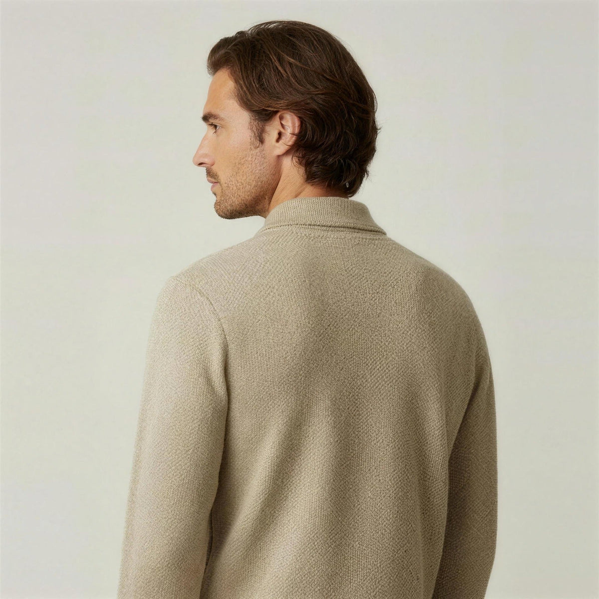 Man wearing beige textured knit polo jumper, shown from behind, worn | Chaps London