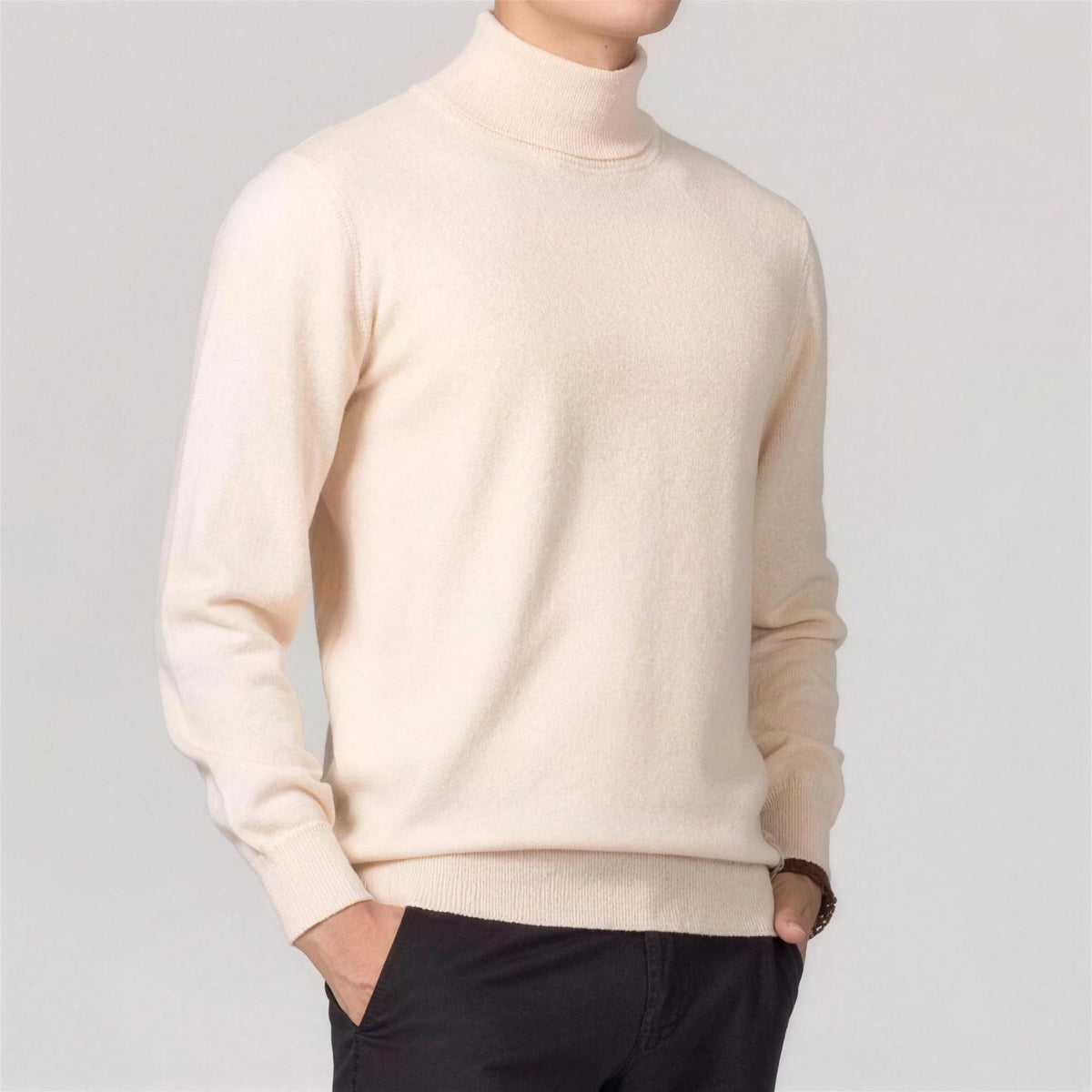 Man wearing cream knit turtleneck sweater with black trousers, side view | Chaps London