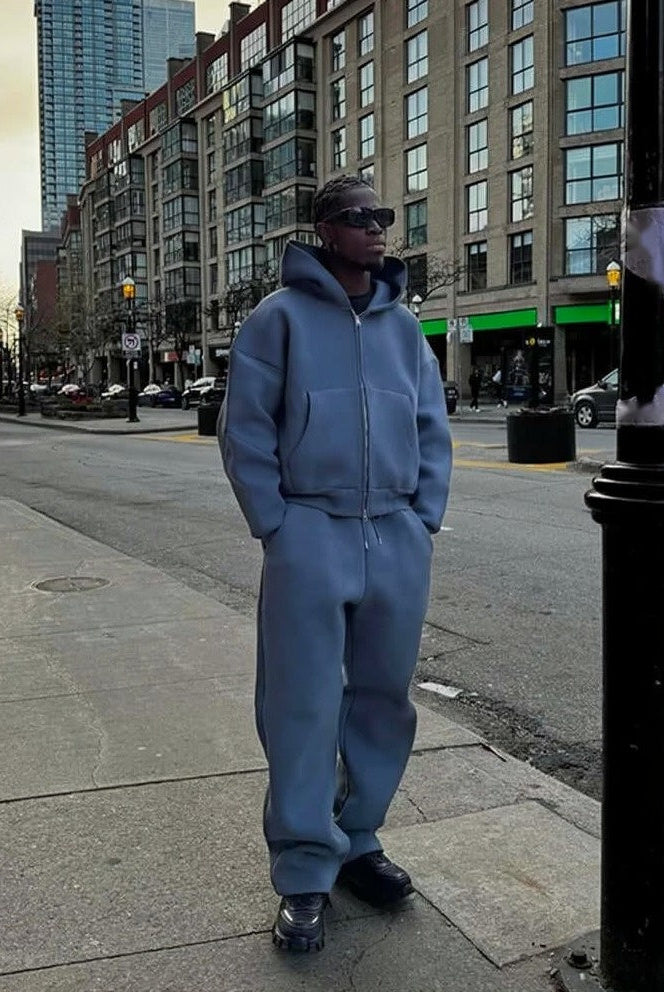 Man wearing gray oversized zip hoodie and wide leg joggers outdoors | Chaps London