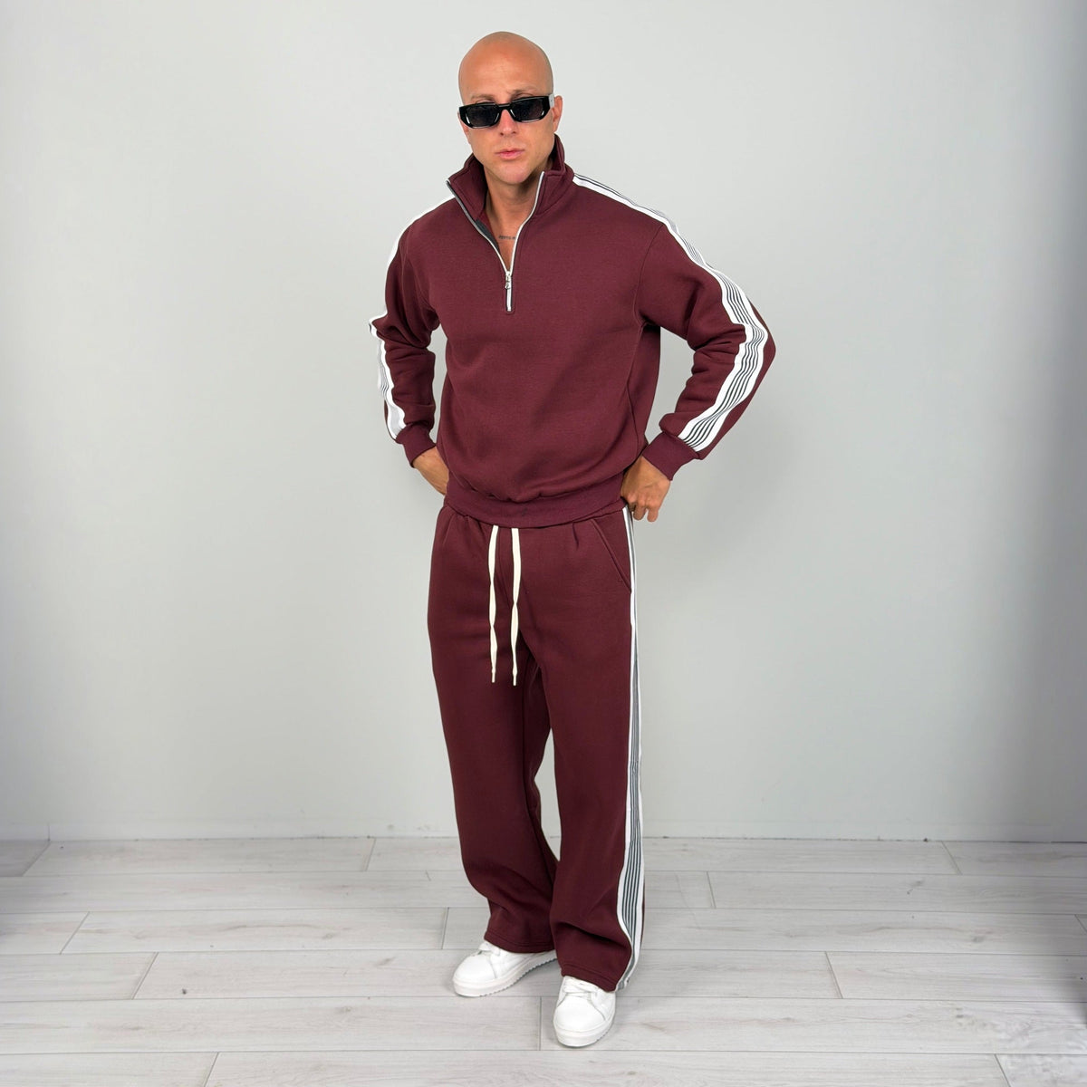 Man wearing burgundy striped half zip tracksuit with wide leg trousers | Chaps London