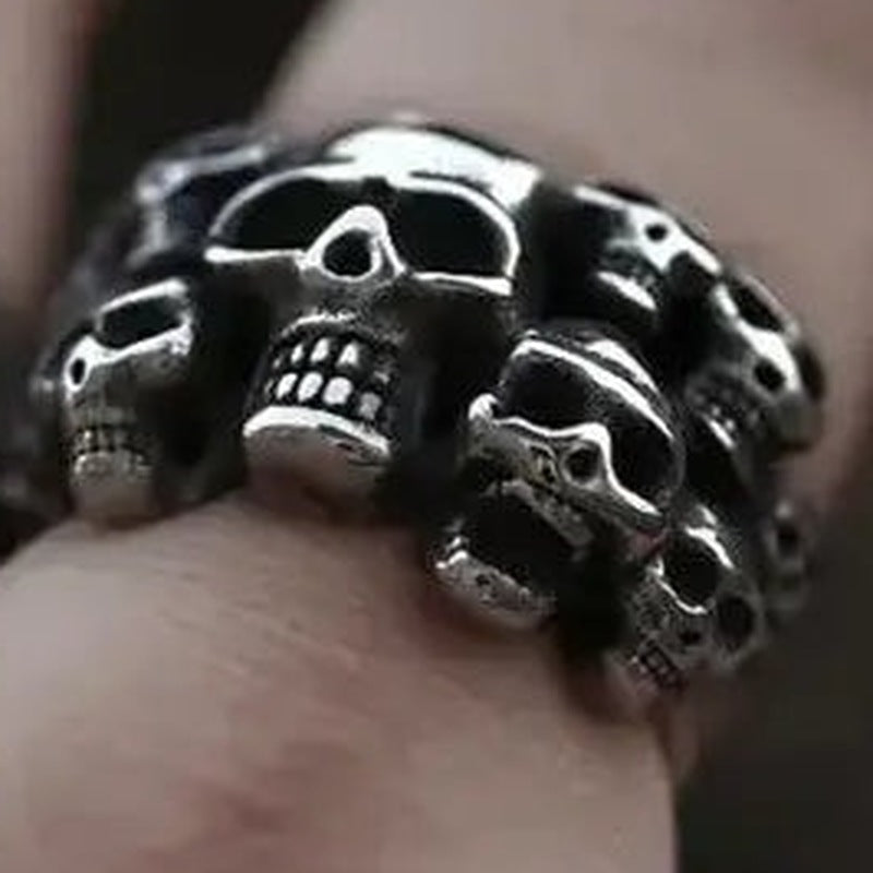 Silver skull row ring worn on finger, multiple skulls, antique finish | Chaps London