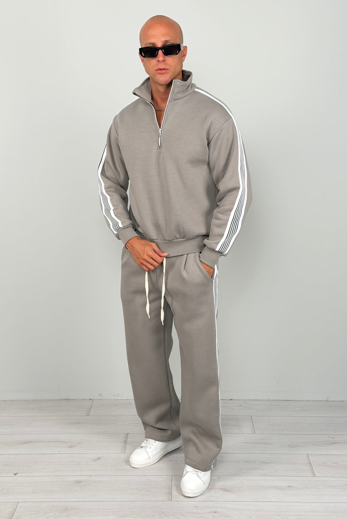 Man wearing grey half zip tracksuit with white stripes, worn outfit | Chaps London