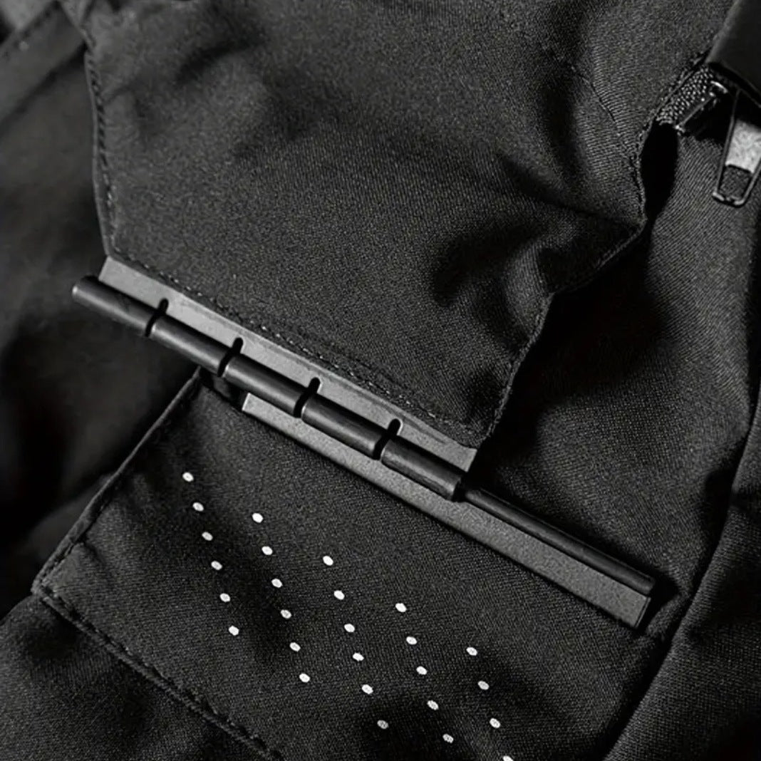 Black jacket closeup showing zipper, pen clip, and reflective dot pattern detail | Chaps London