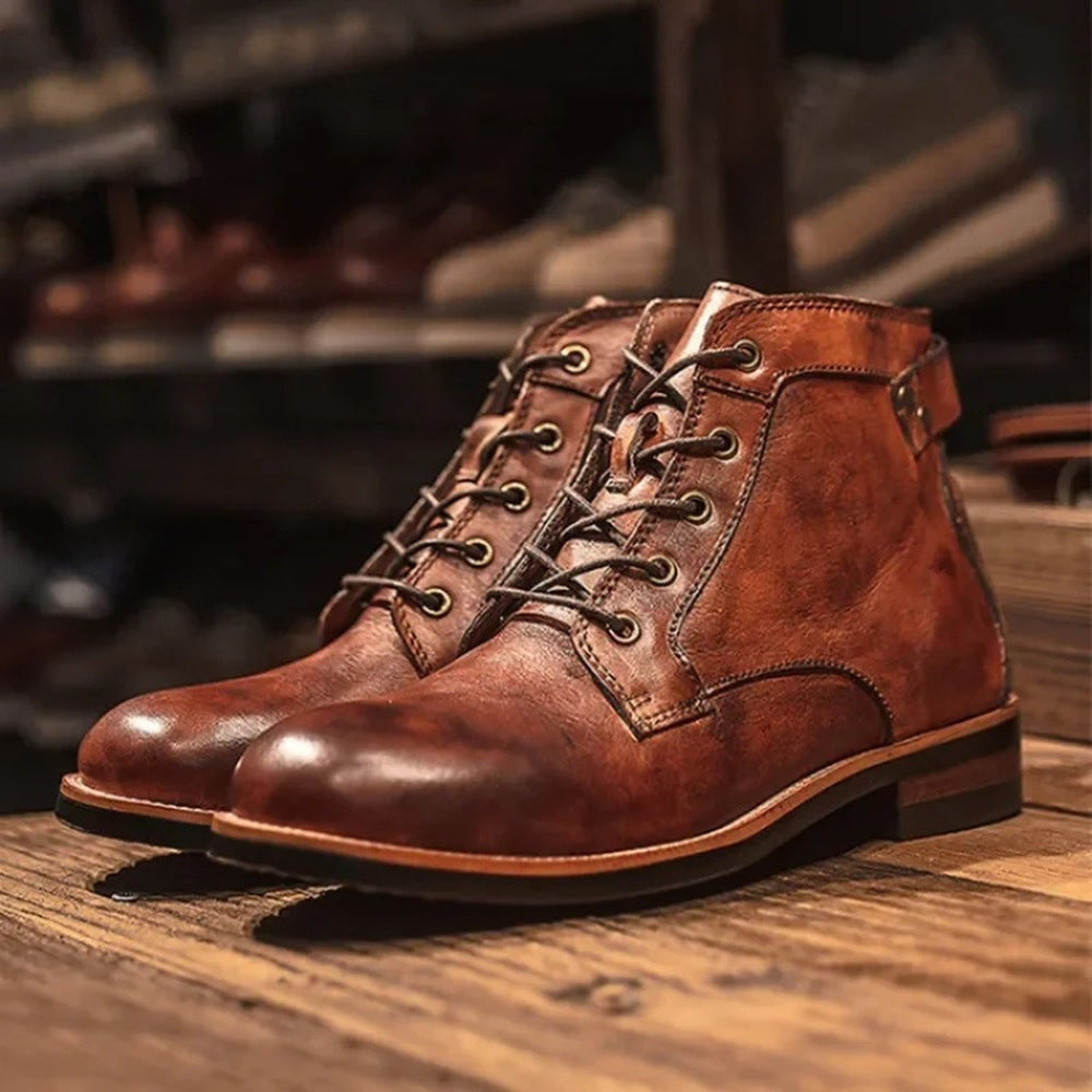 Brown lace-up ankle boots with stacked heel, displayed on wooden surface | Chaps London