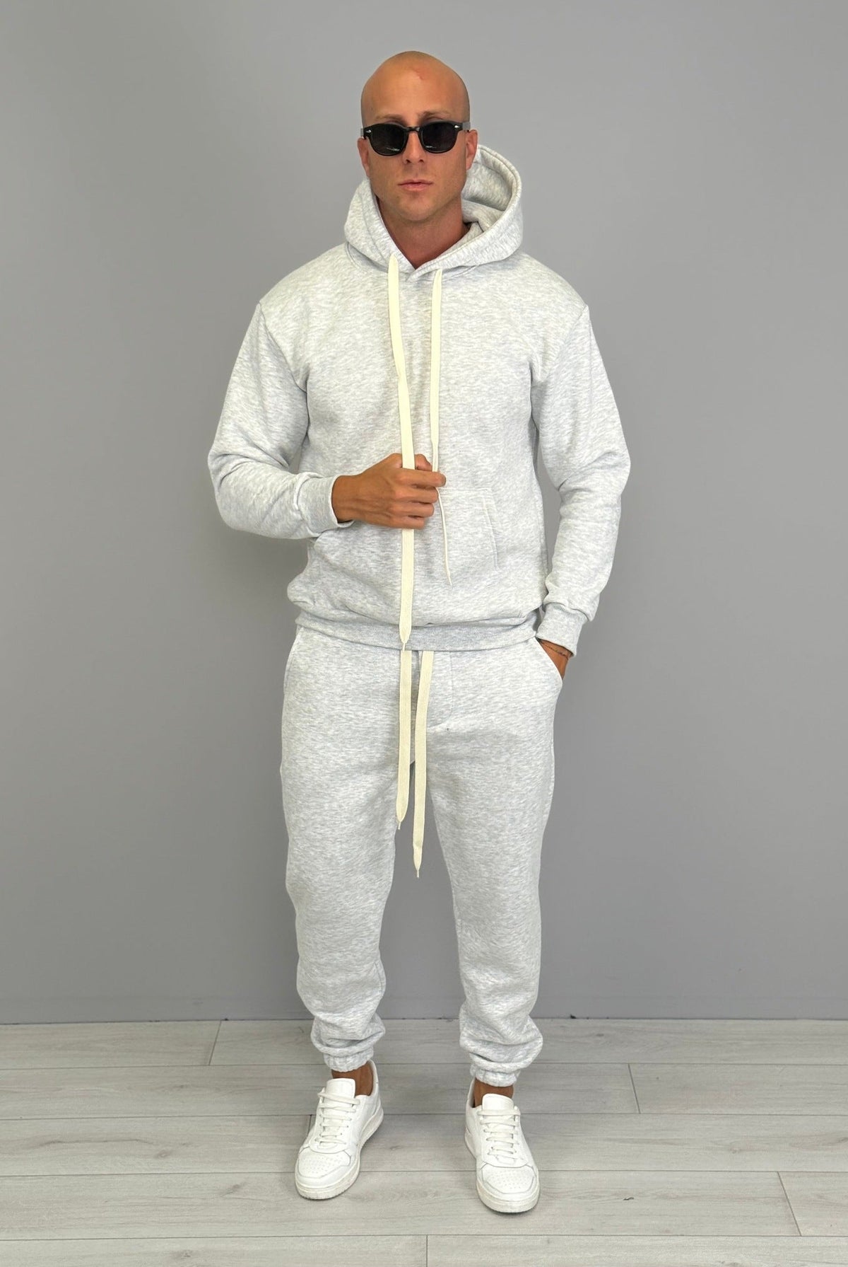 Man wearing grey marl hoodie and matching cuffed jogger tracksuit outdoors | Chaps London