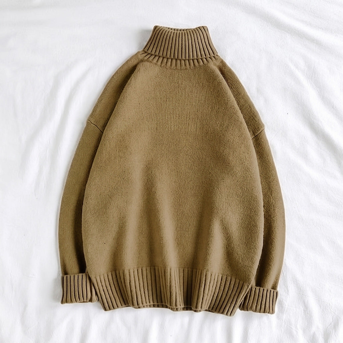Olive green oversized turtleneck sweater, ribbed knit, laid flat on fabric | Chaps London