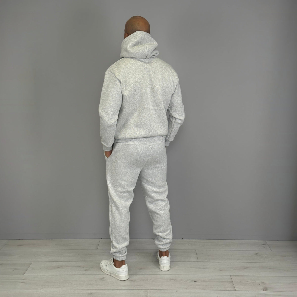 Man wearing grey hoodie and jogger tracksuit, rear view | Chaps London