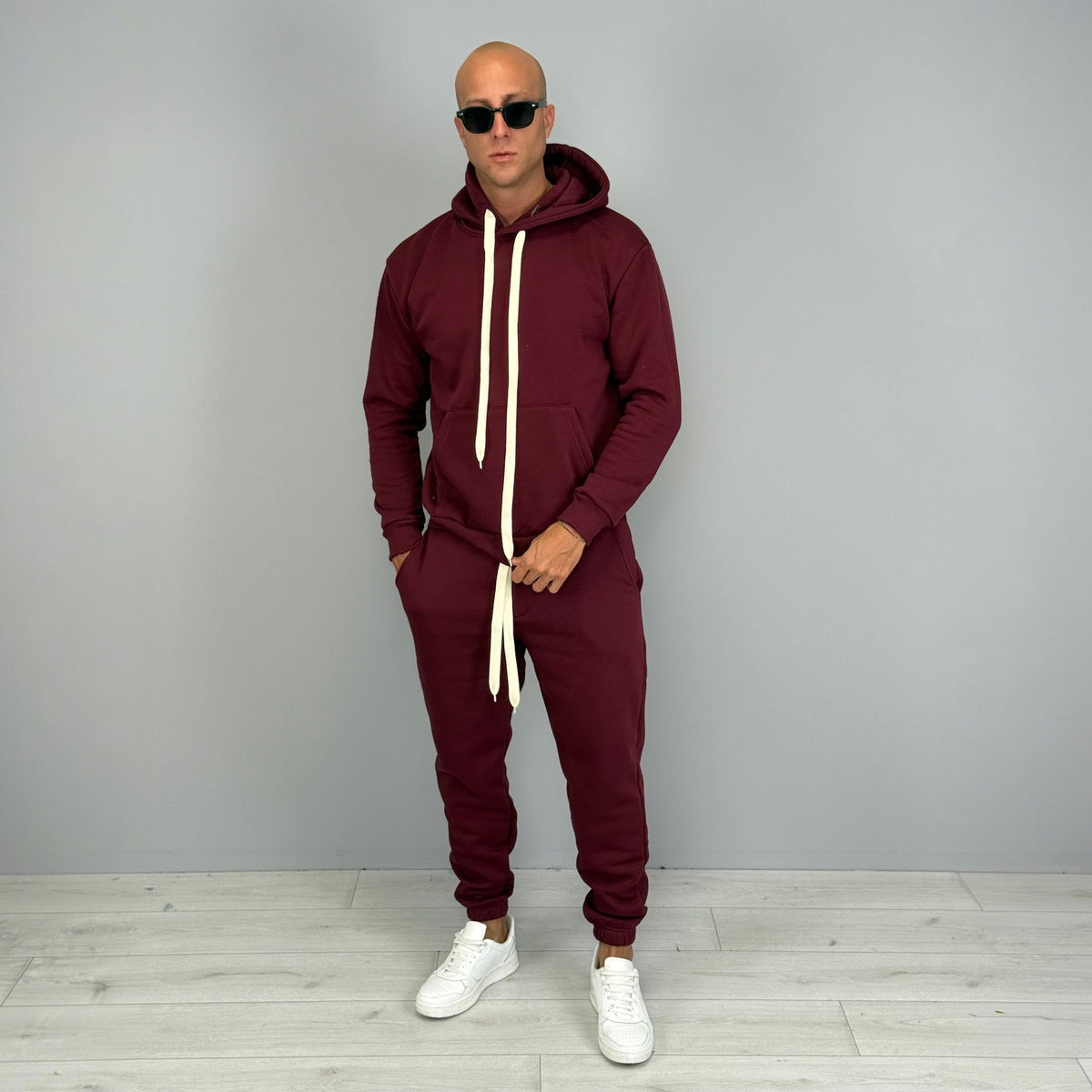 Man wearing burgundy hoodie tracksuit with matching cuffed joggers and white sneakers | Chaps London