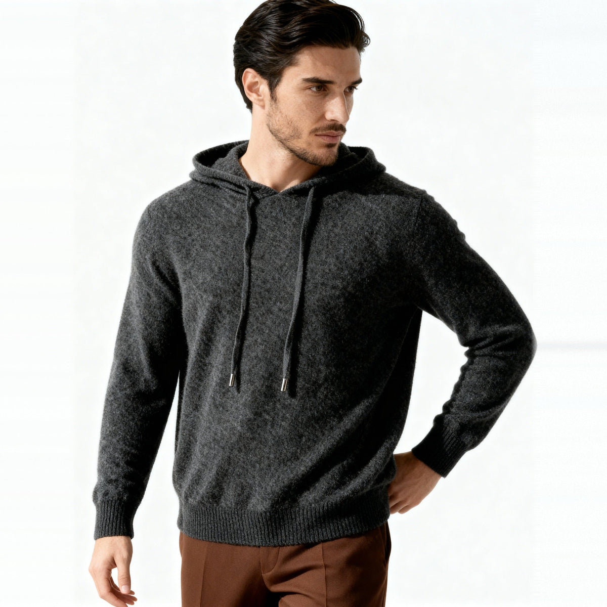Man wearing dark gray knit hooded sweater with drawstring, paired with brown trousers | Chaps London