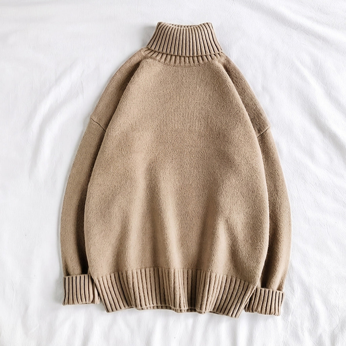 Beige knit turtleneck sweater with ribbed cuffs, laid flat on fabric | Chaps London