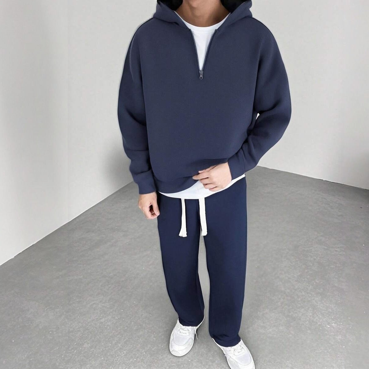 Navy half-zip hoodie and wide-leg joggers worn by a man standing | Chaps London