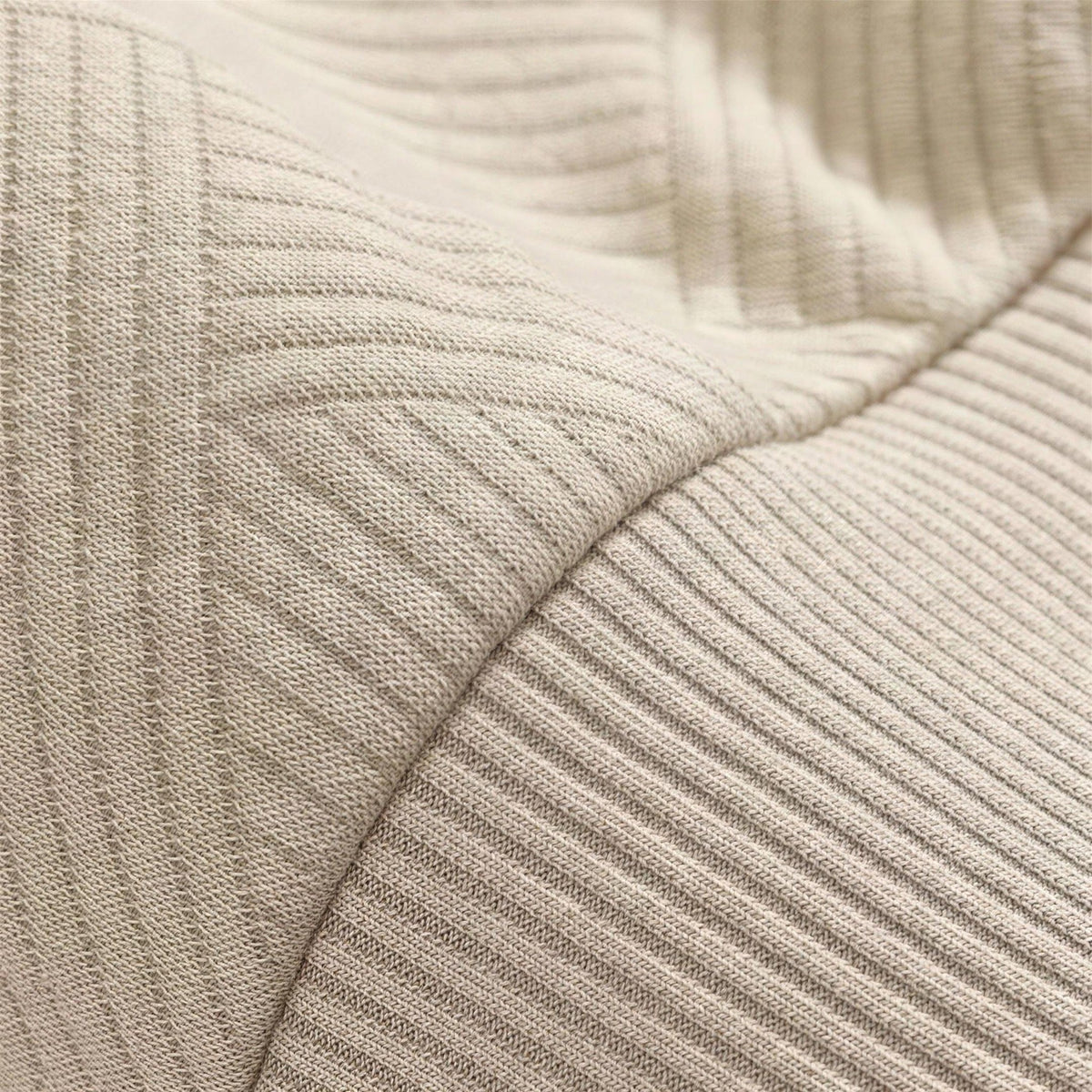 Close-up of beige ribbed knit fabric with textured diagonal stripe pattern | Chaps London