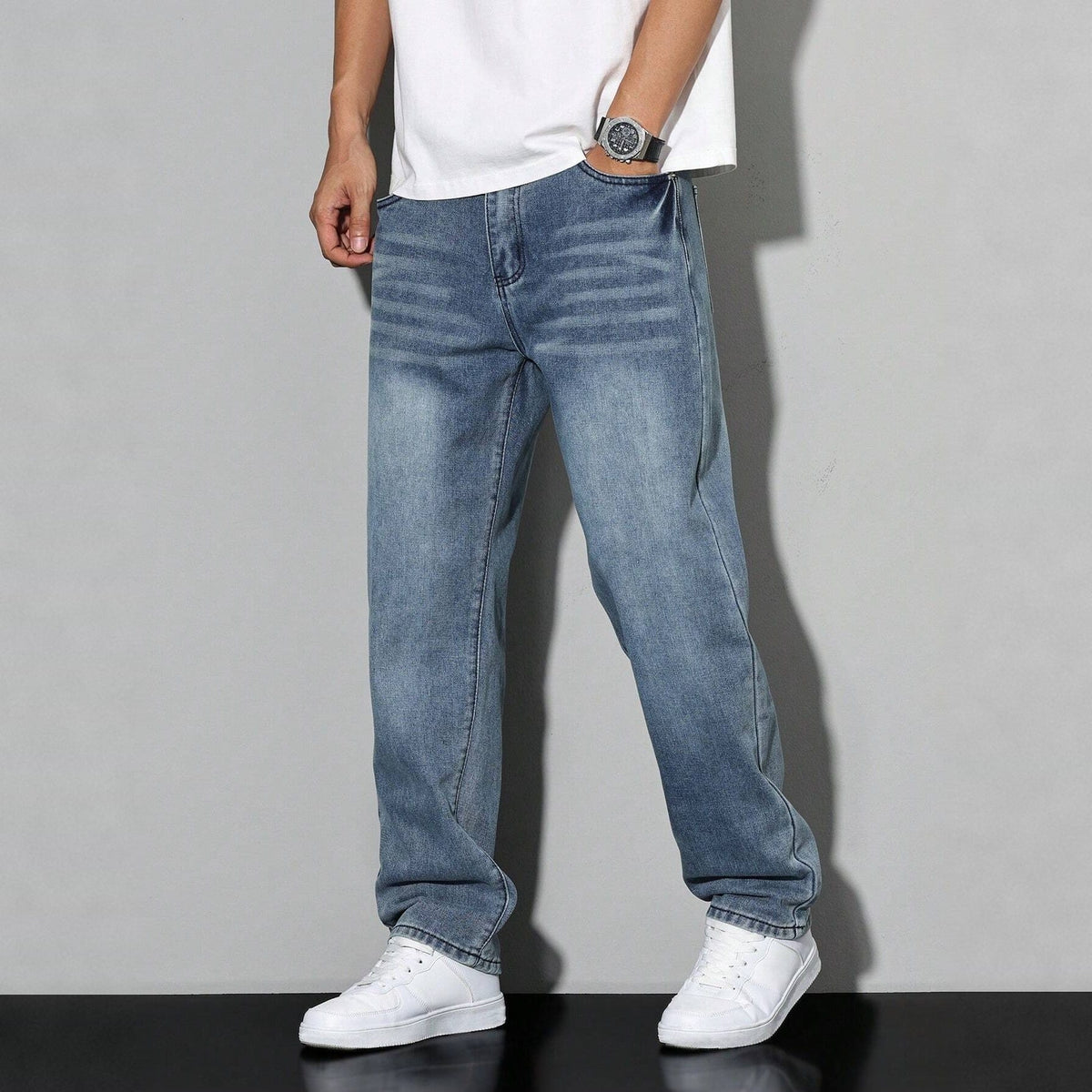 Man wearing light blue washed denim wide leg jeans with white sneakers | Chaps London