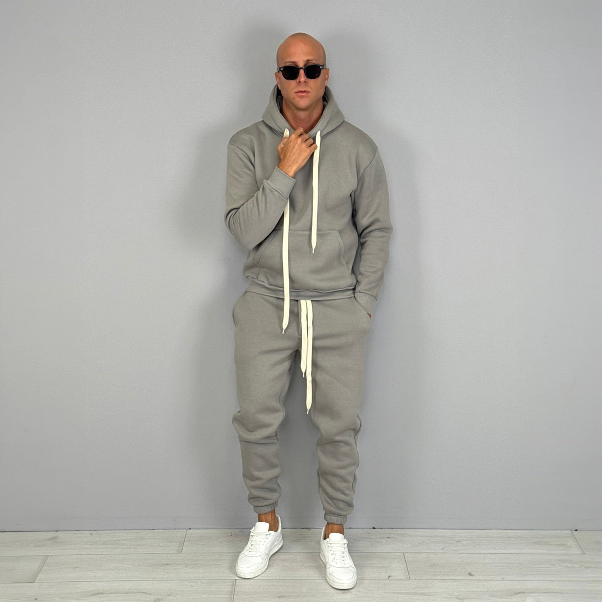 Man wearing grey hoodie and jogger tracksuit with white sneakers | Chaps London