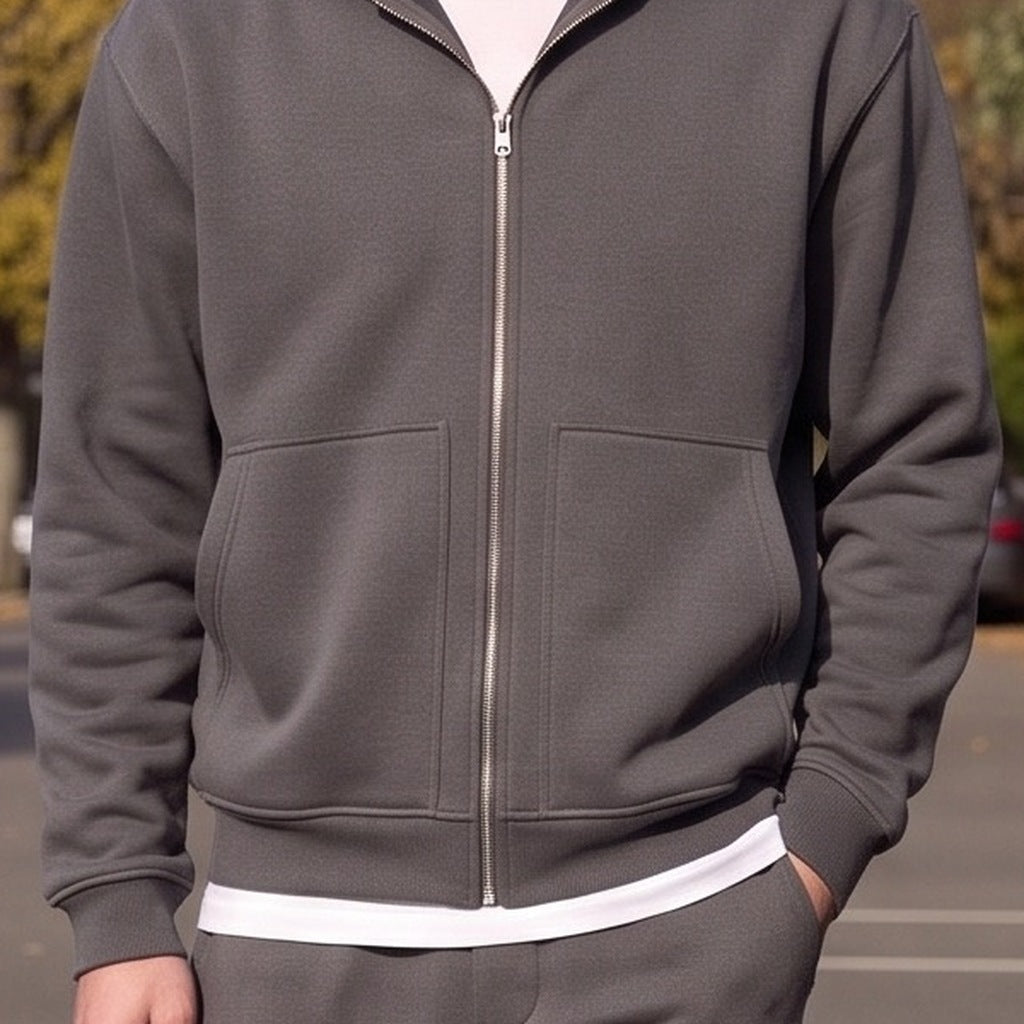 Dark grey zip-up hoodie worn by man standing outdoors | Chaps London