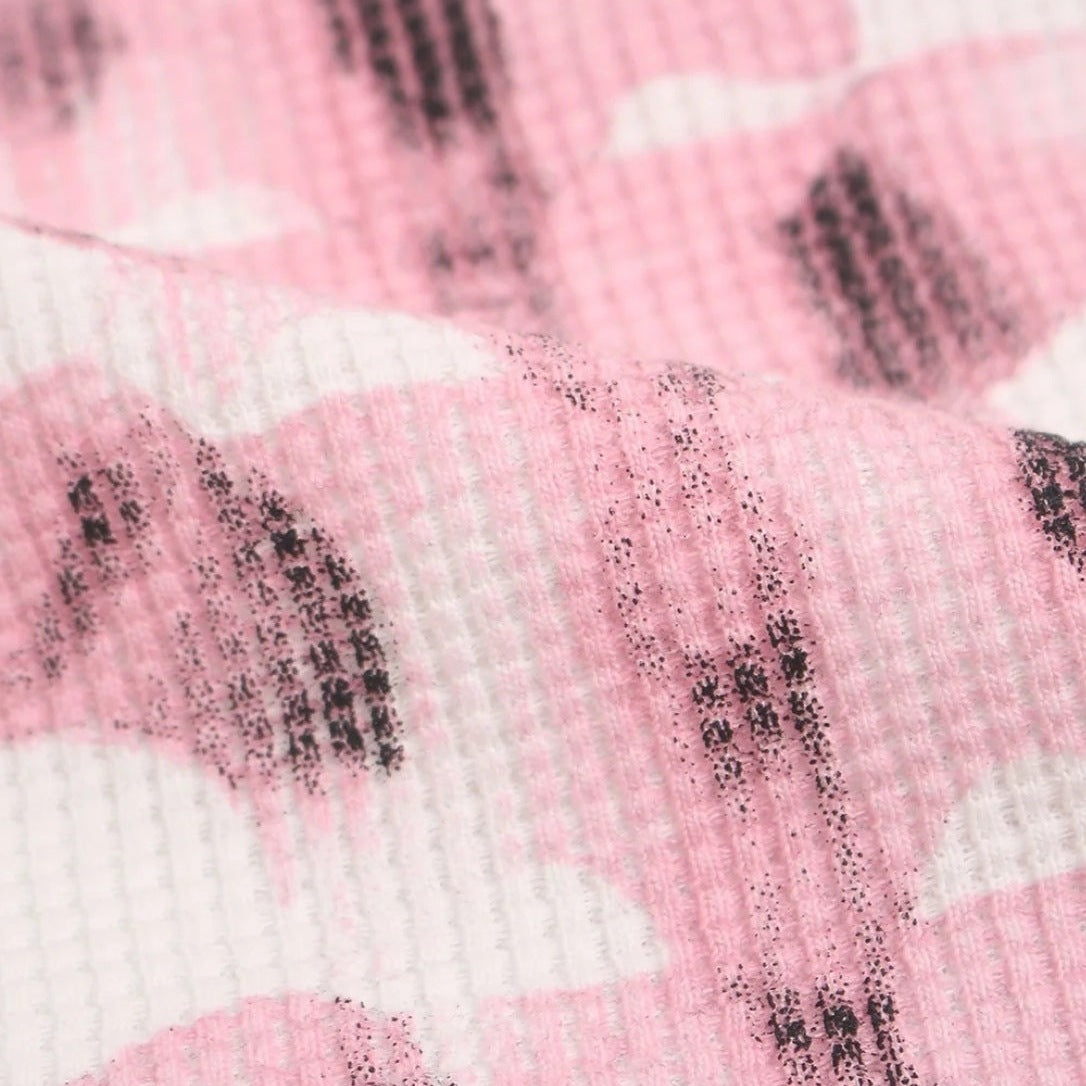 Close-up waffle-textured fabric with pink and white cloud-like pattern | Chaps London